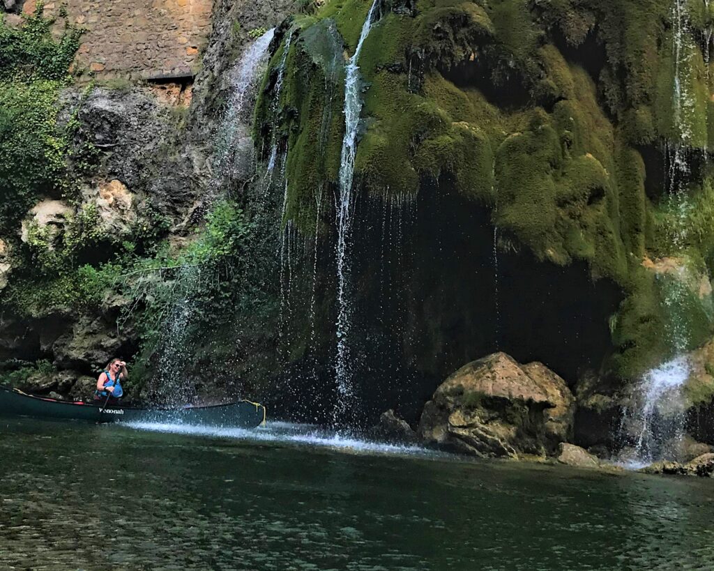 Jenna in a waterfall on the River Tarn